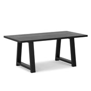 Simpli-Home Whitley dining table with wooden surface and sturdy legs, ideal for modern dining room settings.