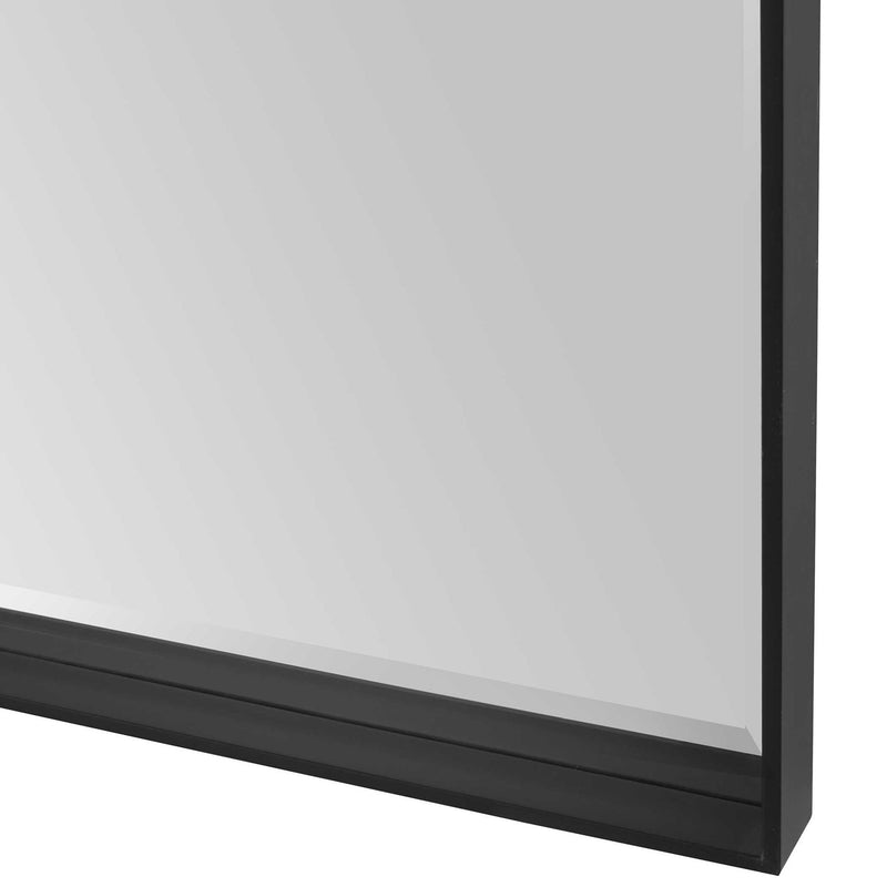 Uttermost Kahn oversized rectangular black accent mirror with a sleek modern frame, hanging on a wall.