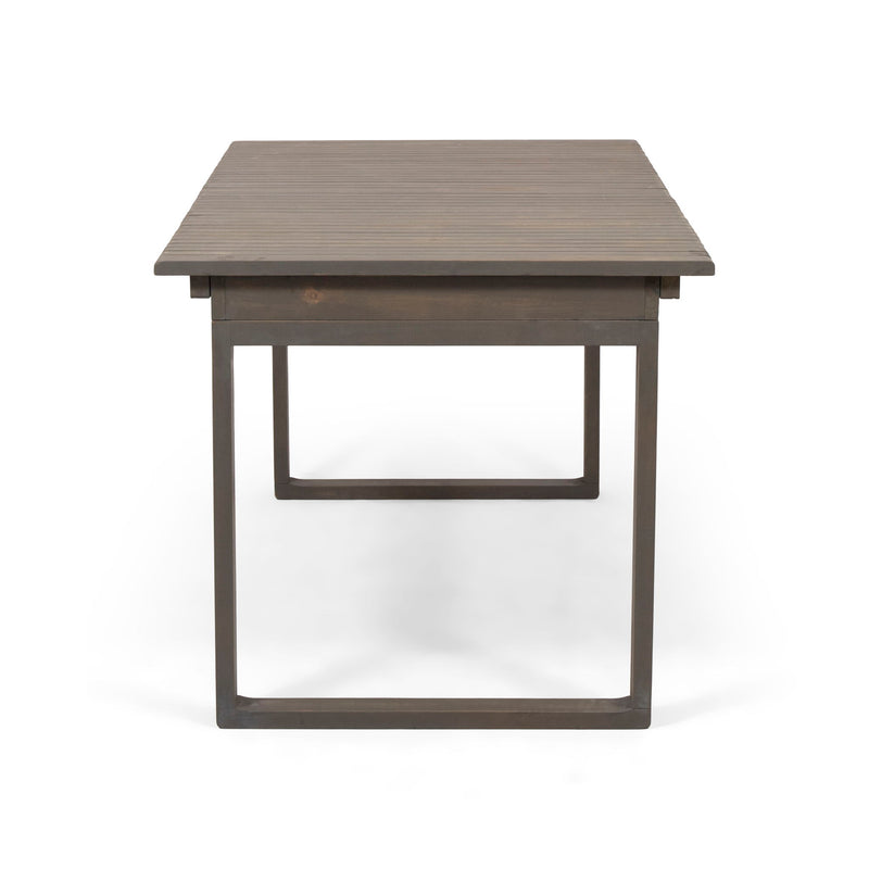 Outdoor expandable acacia wood dining table with U-shaped legs by Noble House, showing the natural wood grain and adjustable length.