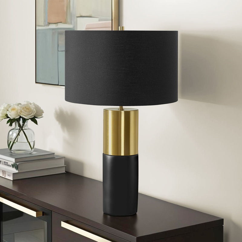 Contemporary black and gold concrete table lamp with a sleek, modern design, perfect for stylish home lighting.