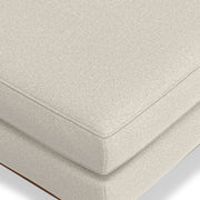 Simpli-Home Morrison handcrafted upholstered ottoman with cushioned top and wooden legs, ideal as a versatile living room accent piece.