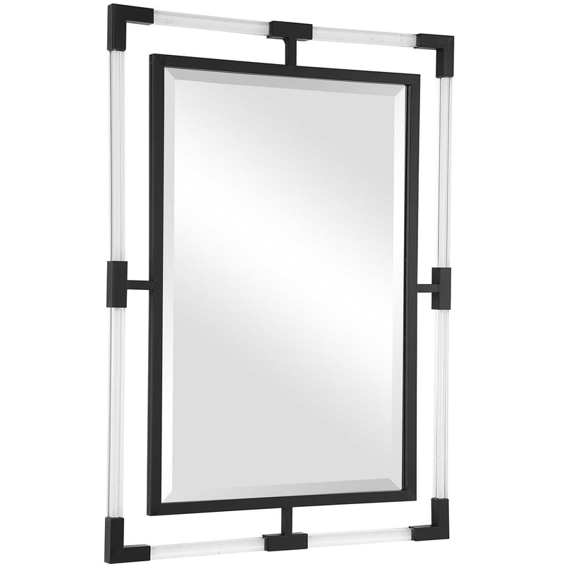 Uttermost Balkan iron wall mirror with a decorative round frame, hanging on a neutral-colored wall.