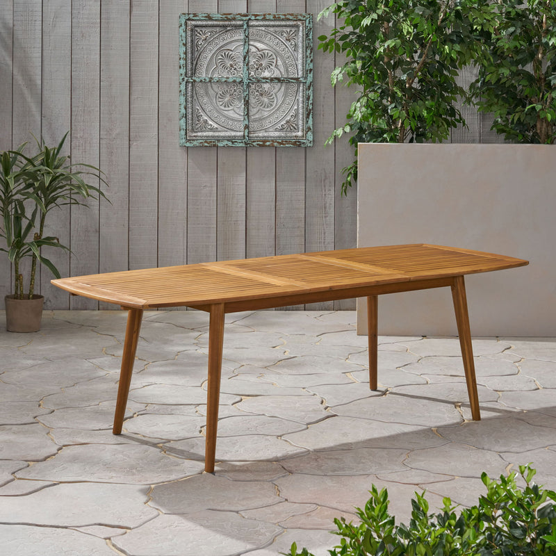 Outdoor expandable dining table by Noble House with slatted tabletop and tapered legs, perfect for patio or garden dining.