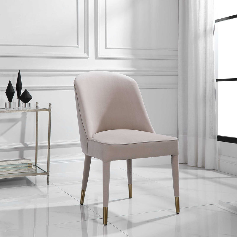 Set of two Uttermost Brie armless chairs with beige upholstery and wooden legs, modern design perfect for living room or lounge.