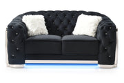 Glory Furniture stationary loveseat with flared arms, upholstered in neutral fabric, shown in a cozy living room setting.