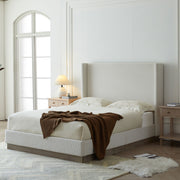 House & Home Furniture Hale upholstered wingback bed with padded headboard and fabric upholstery, shown in a modern bedroom setting.