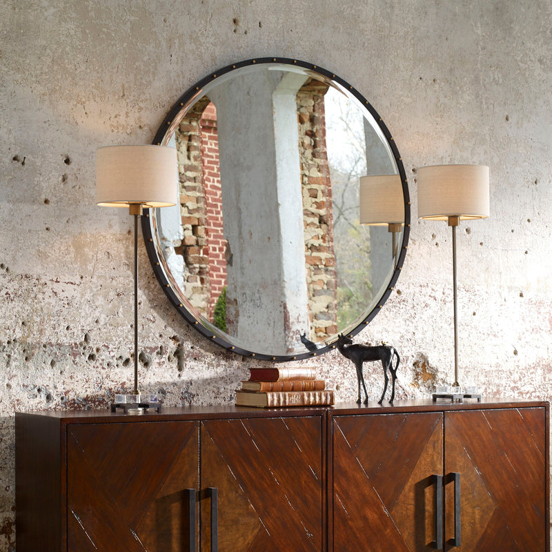 Black round wall mirror by Uttermost with a sleek frame, perfect for modern interior decor.