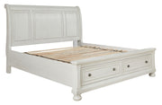 Ashley Robbinsdale Sleigh 6-piece bedroom set with a wooden sleigh bed, matching dressers, and nightstands in a classic bedroom style.