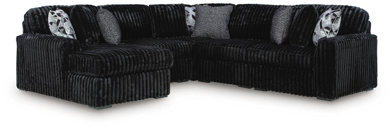 Signature Design by Ashley Midnight-Madness stationary sectional with plush cushions and dark fabric upholstery.