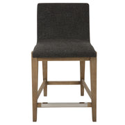 Uttermost Klemens counter stool with wooden legs and upholstered seat in a modern design, suitable for kitchen or bar area.