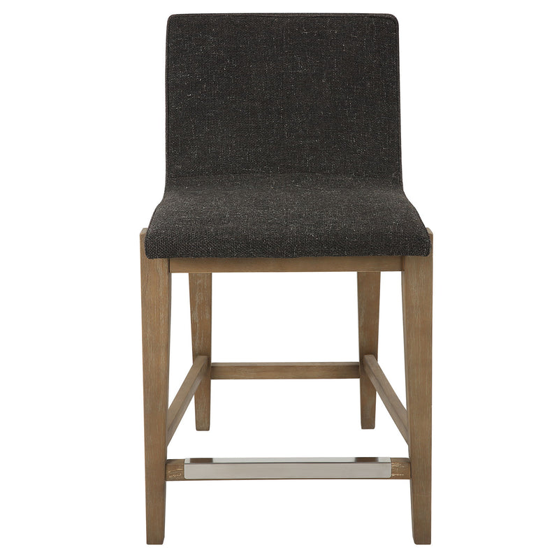 Uttermost Klemens counter stool with wooden legs and upholstered seat in a modern design, suitable for kitchen or bar area.