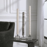 Set of three Pearl Silver cylindrical sculptures by Uttermost, modern decorative figurines with sleek, metallic finishes.