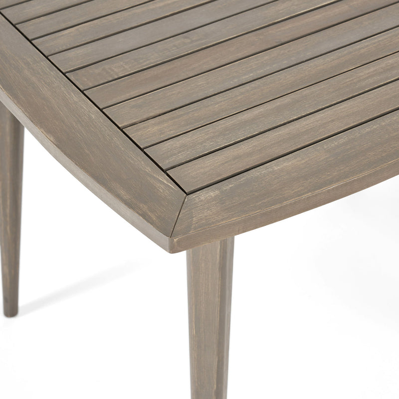 Modern indoor square dining table by Noble House with acacia wood surface and toothpick leg design, showcasing a sleek, stylish look.