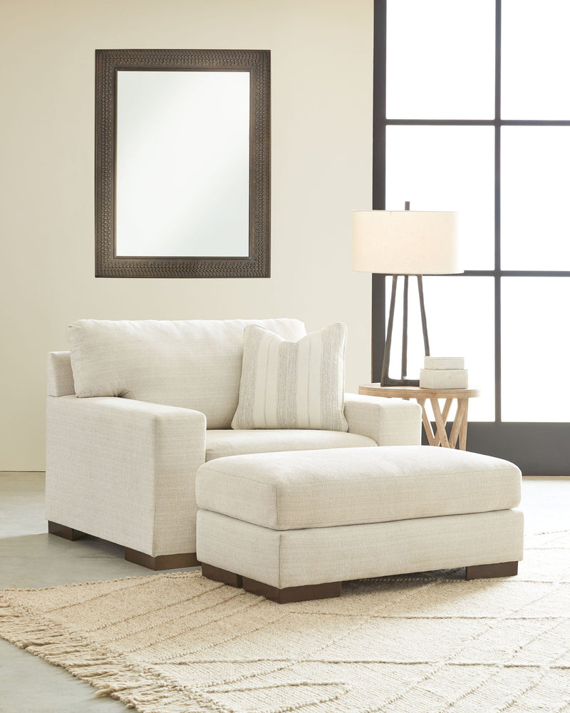 Signature Design by Ashley Maggie living room set with stationary chair and ottoman, featuring plush upholstery and modern style.