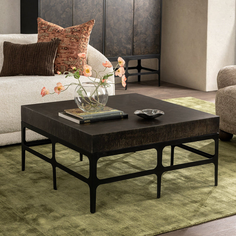 Rust Noir Adela coffee table by Classic Home featuring a sleek, modern design with a dark finish and sturdy metal legs.