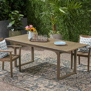 Outdoor expandable acacia wood dining table with U-shaped legs by Noble House, showing the table's surface and sturdy design.