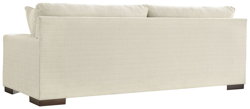 Signature Design by Ashley Maggie stationary sofa with plush cushions and neutral upholstery, ideal for contemporary living rooms.