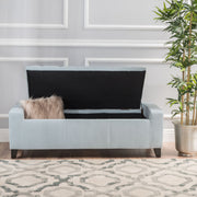 Noble House Guernsey storage ottoman with tufted top and wooden legs, serving as a versatile ottoman and hidden storage solution.