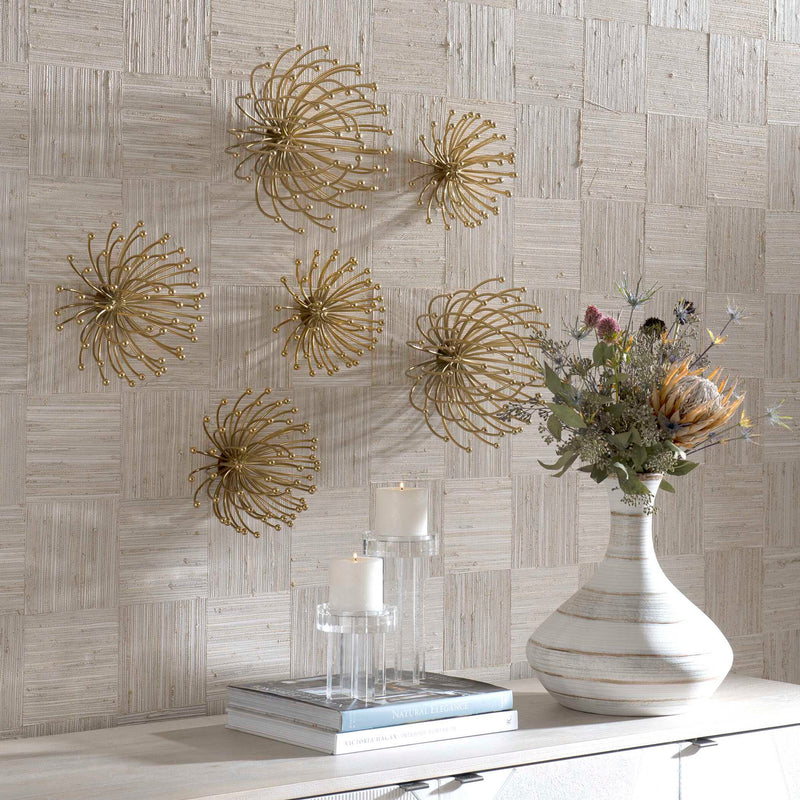Set of three gold metal wall decor pieces by Uttermost, featuring modern geometric designs for stylish wall accents.
