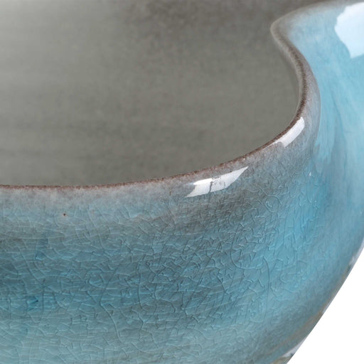 Uttermost Blue Crest ceramic bowl in blue, showcasing its smooth round shape and glossy glazed finish.