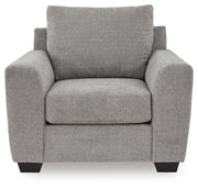 Benchcraft® Loreo arm chair with plush fabric upholstery and padded armrests, shown in a cozy living room setting.