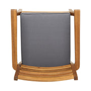 Set of two outdoor dining chairs with slat back design, gray fabric seats, and acacia wood frames by Noble House.
