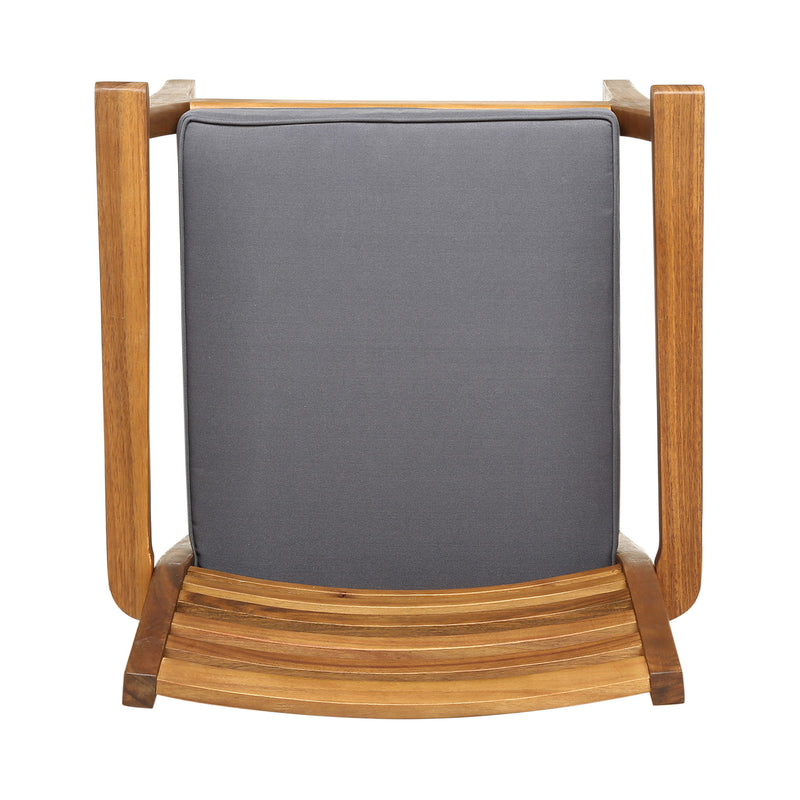 Set of two outdoor dining chairs with slat back design, gray fabric seats, and acacia wood frames by Noble House.