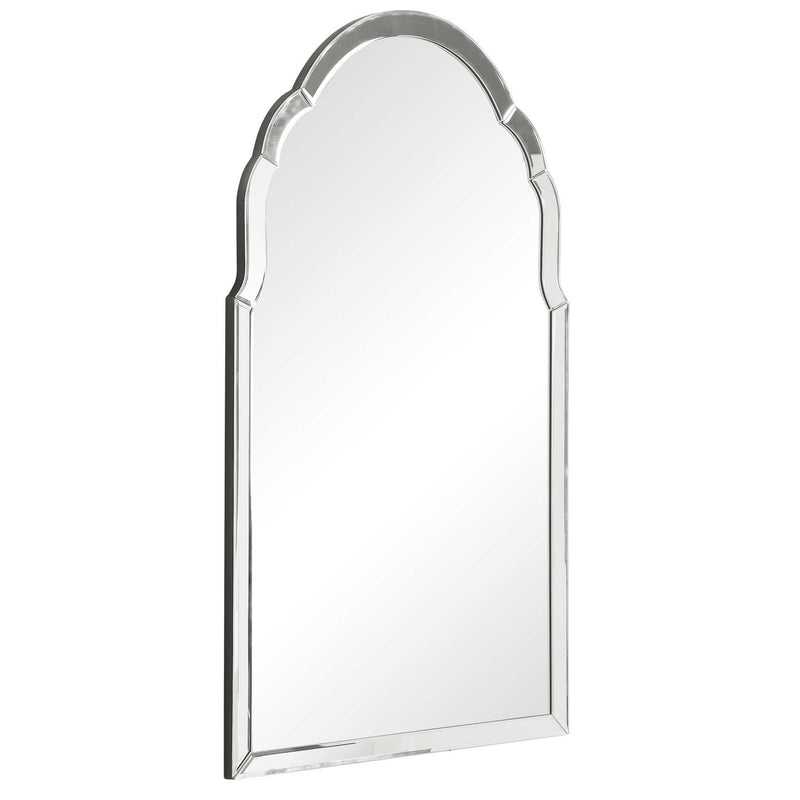 Uttermost Brayden frameless arched wall mirror with pearl silver finish, showcasing a sleek, curved design hanging on a wall.