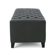 Dark gray Noble House storage ottoman with a tufted top, serving as a stylish and functional living room storage solution.