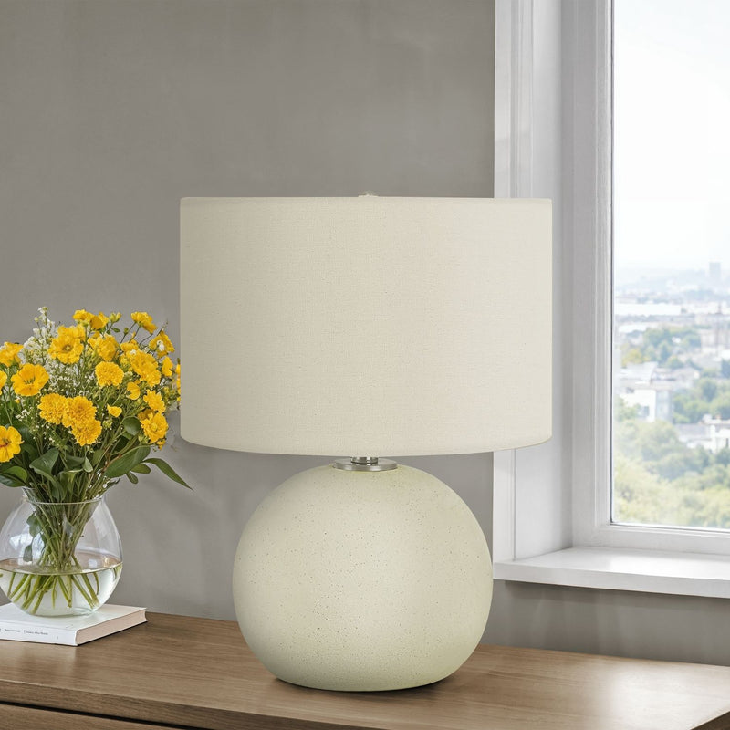 Contemporary cream ceramic table lamp by 8th Street with a sleek, modern design and smooth finish.