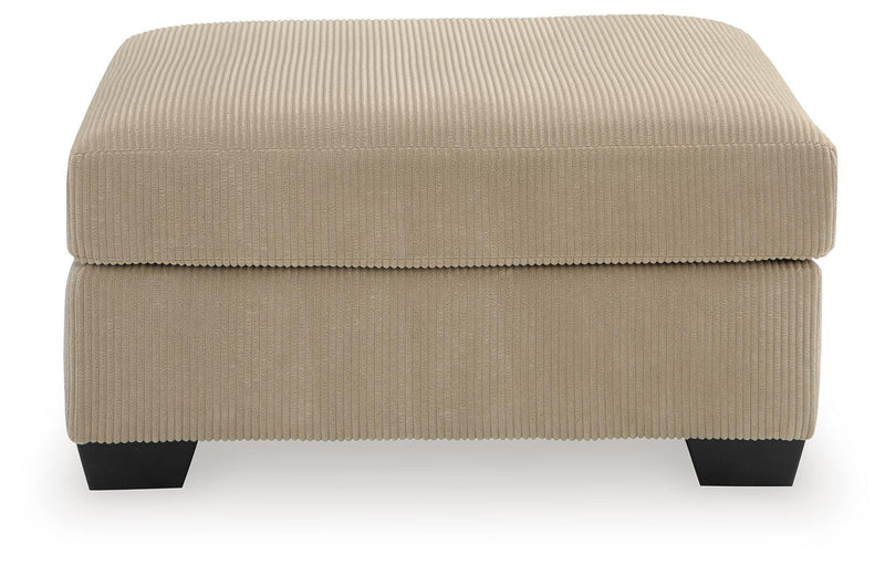 SimpleJoy oversized accent ottoman by Signature Design Ashley, showing plush fabric and sturdy wooden legs in a modern living room.