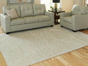 Signature Design by Ashley Jaseena area rug with intricate pattern in neutral tones, showcasing a plush, woven texture.