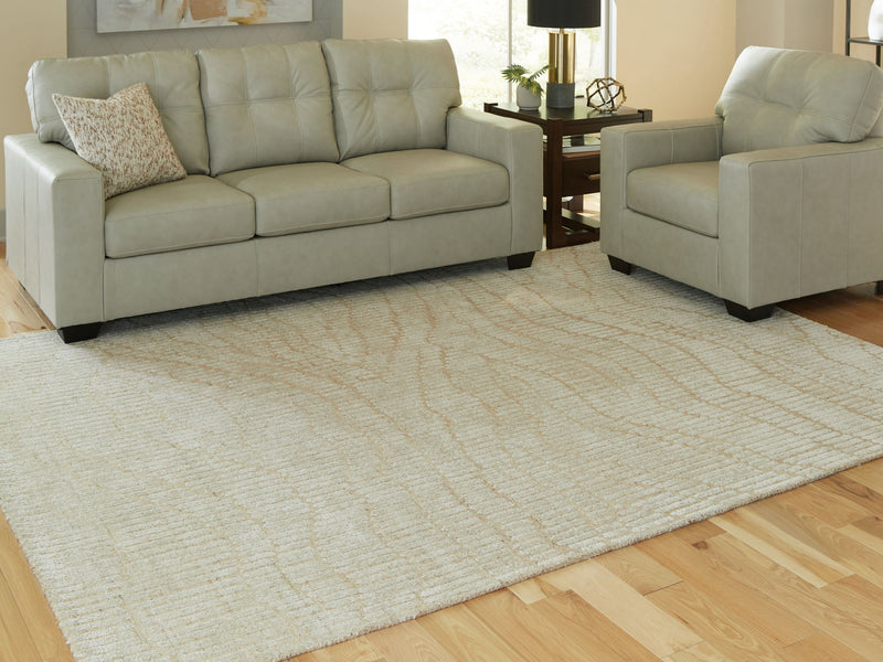 Signature Design by Ashley Jaseena area rug with intricate pattern in neutral tones, showcasing a plush, woven texture.
