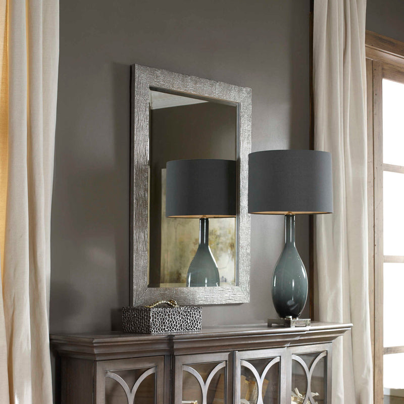 Uttermost Tarek silver wall mirror with a sleek, modern frame, hanging on a wall for stylish home decor.