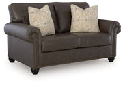 Benchcraft Roxmere living room set with stationary chair and matching ottoman, featuring plush upholstery and stylish design.