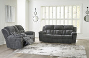 Comfortable reclining sofa from the Frohn Signature Design by Ashley® living room set, featuring plush cushions and a modern style.