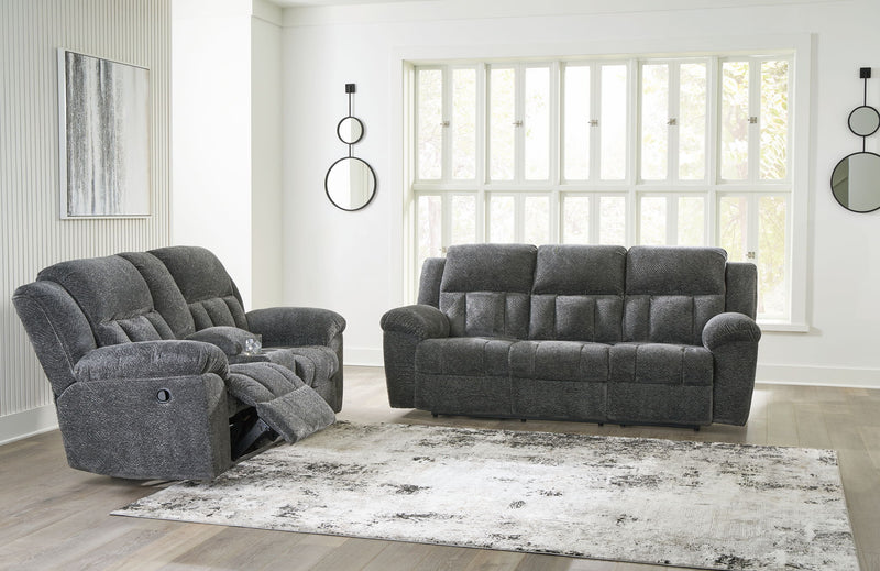 Comfortable reclining sofa from the Frohn Signature Design by Ashley® living room set, featuring plush cushions and a modern style.