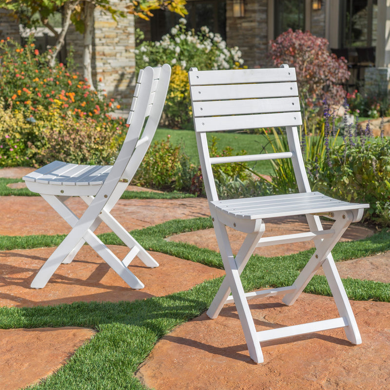 Set of two outdoor foldable wooden dining chairs with slat design by Noble House, ideal for patio or garden seating.