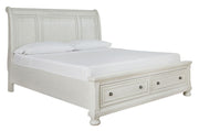 Ashley Robbinsdale sleigh bedroom set featuring a bed frame, nightstands, dresser, mirror, and chest in a coordinated design.