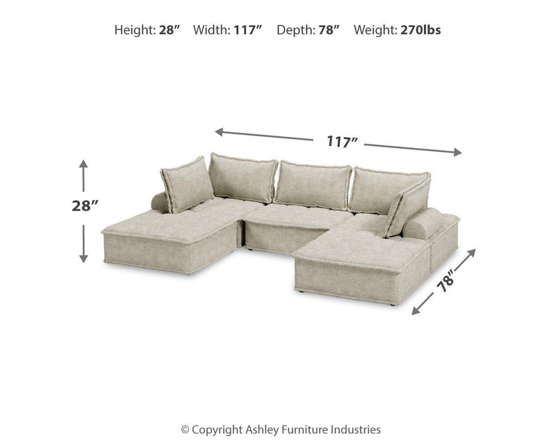 Signature Design by Ashley stationary sectional sofa with plush cushions and neutral fabric upholstery in a modern living room setting.