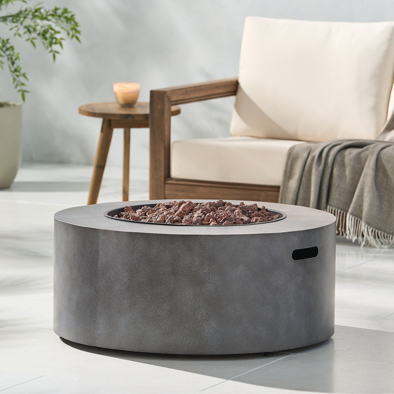Round Noble House iron fire pit with 40,000 Btu, featuring a sturdy metal design and a spacious top for outdoor fires.