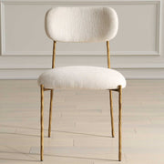 Set of two Capture dining chairs by Uttermost with gold metal legs and white upholstered seats, modern and elegant for dining rooms.