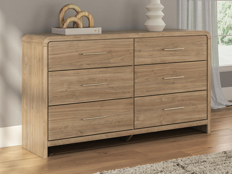 Signature Design by Ashley six-drawer dresser in warm wood finish with sleek modern handles and spacious storage drawers.
