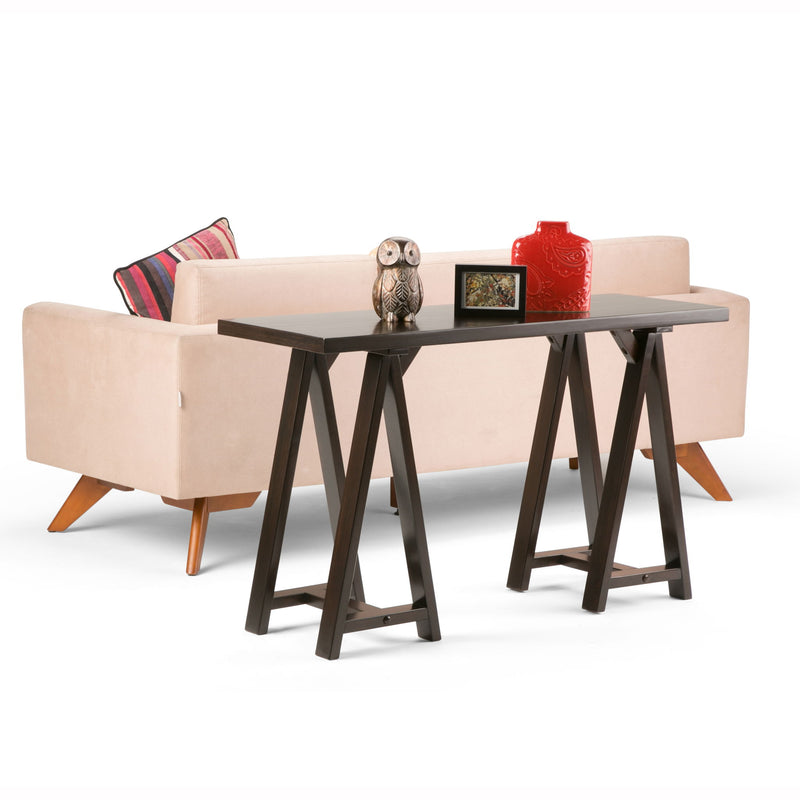 Handcrafted Simpli-Home console sofa table with sawhorse-style legs, featuring a smooth wooden surface and modern design.