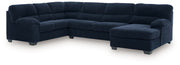 Signature Design by Ashley SimpleJoy stationary sectional sofa with plush cushions and neutral fabric in a modern living room setting.