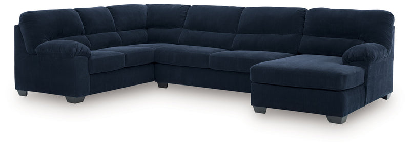 Signature Design by Ashley SimpleJoy stationary sectional sofa with plush cushions and neutral fabric in a modern living room setting.