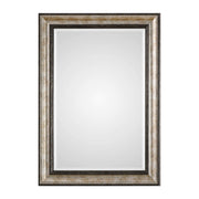 Uttermost Shefford wall mirror with antiqued silver finish, round shape, ornate frame, hanging on a neutral wall.