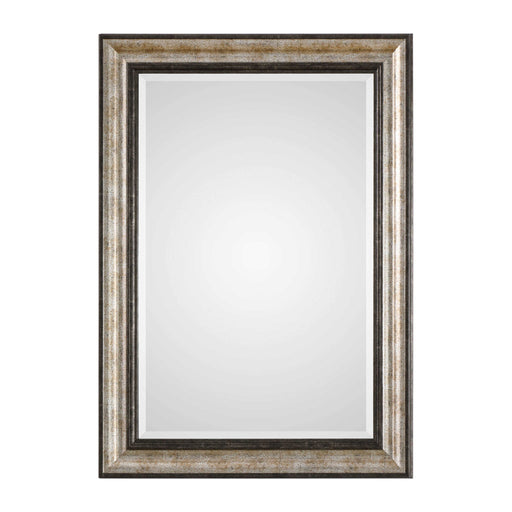 Uttermost Shefford wall mirror with antiqued silver finish, round shape, ornate frame, hanging on a neutral wall.