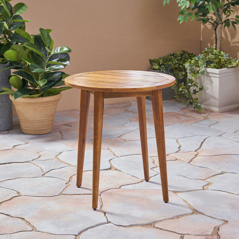 Noble House Stamford modern outdoor teak bistro table with water-resistant finish, suitable for patio or garden dining.