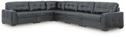 Signature Design by Ashley Brindley Pier stationary sectional sofa with plush cushions and modern design in a living room setting.